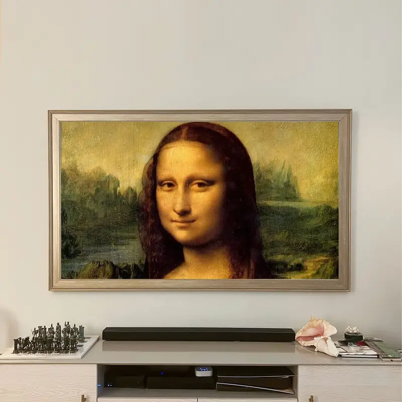 Frame TV with a silver bezel displaying the Mona Lisa, mounted flush like framed art