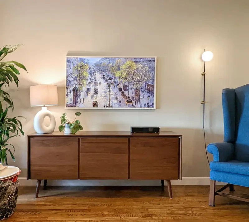 Samsung Frame TV mounted in a white built-in niche over a long credenza, one of our installs